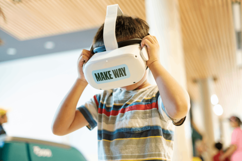 Boy interacts with Branksome Hall iCAST building VR Experience by Cicada Design for Branksome Hall. Toronto, Ontario, Canada