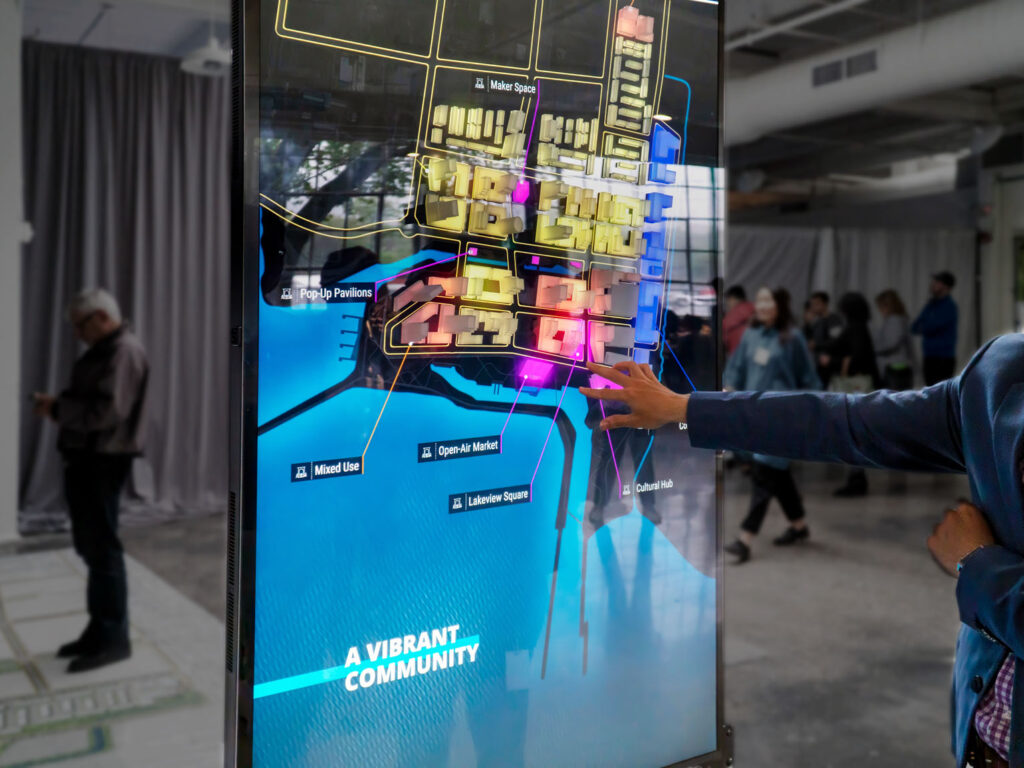 Lakeview Village 3D printed masterplan model on digital display with animated graphics by Cicada Design for Lakeview Village Community Partners. Mississauga, Ontario, Canada